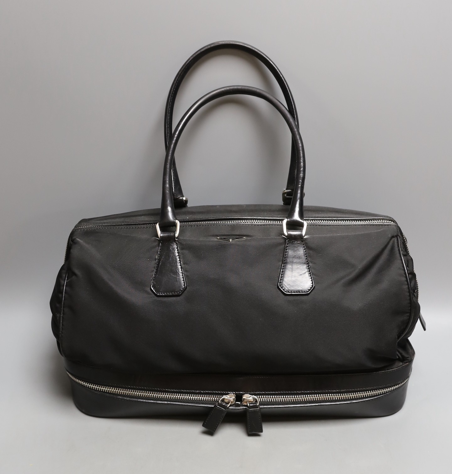 A Prada bowling bag style with zip up compartment